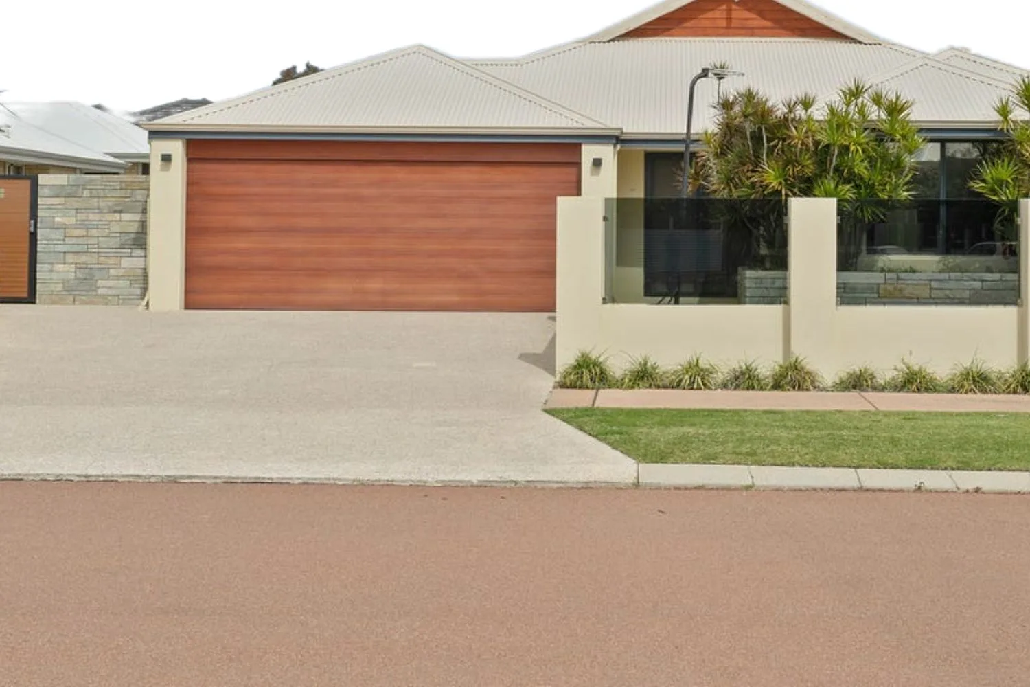 A concrete driveway crossover connecting to the road